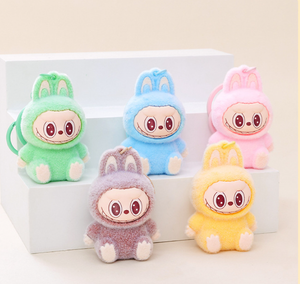 Five colorful fuzzy Keychains with bunny ears on a light background with steps