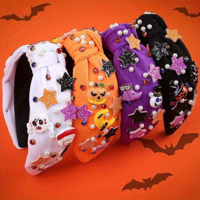 Four Halloween-themed headbands with decorative elements on an orange background with bat silhouettes.