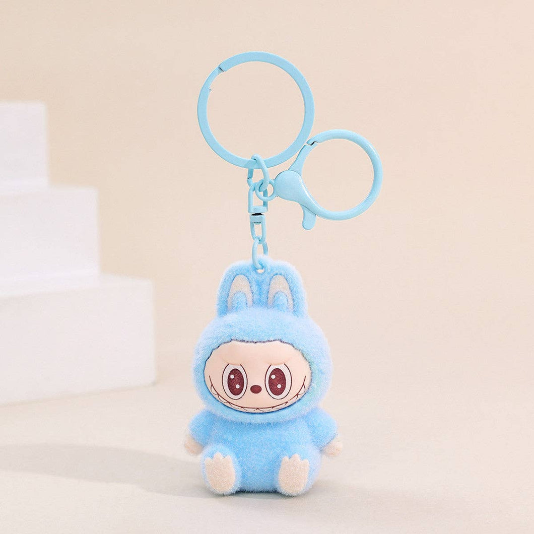 Fuzzy light blue Labubu Keychain on a beige background