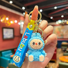 Load image into Gallery viewer, Blue Labubu cartoon character keychain held in a hand with a colorful background
