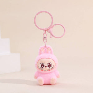 Fuzzy light pink Labubu Keychain on a beige background