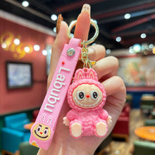 Load image into Gallery viewer, Pink &#39;Labubu&#39; keychain held in a hand with a blurred restaurant interior background
