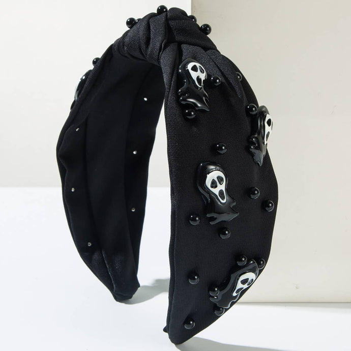 Black headband with skull and bone decorations on a white background