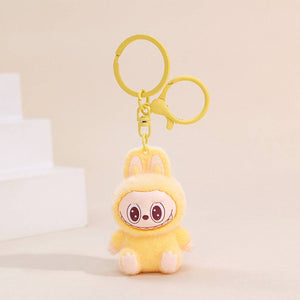 Fuzzy yellow Labubu Keychain on a beige background